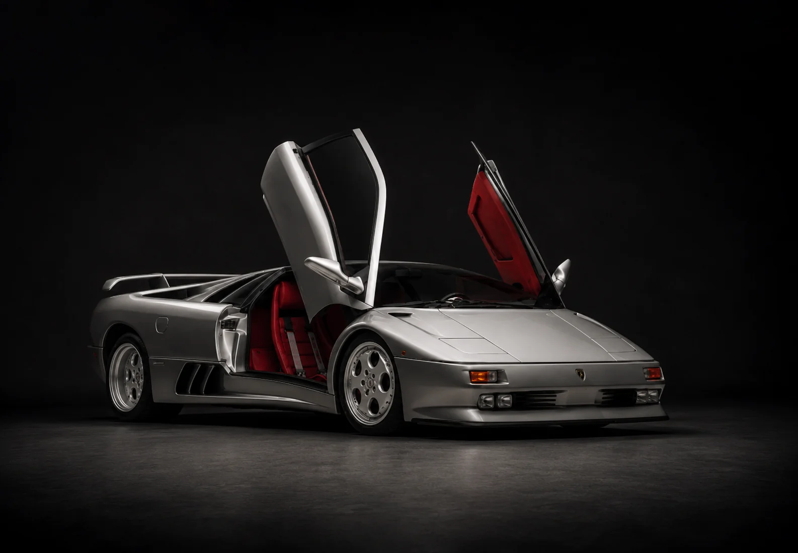Red Alcantara cabin of the Diablo SE30 seen through the raised scissor door